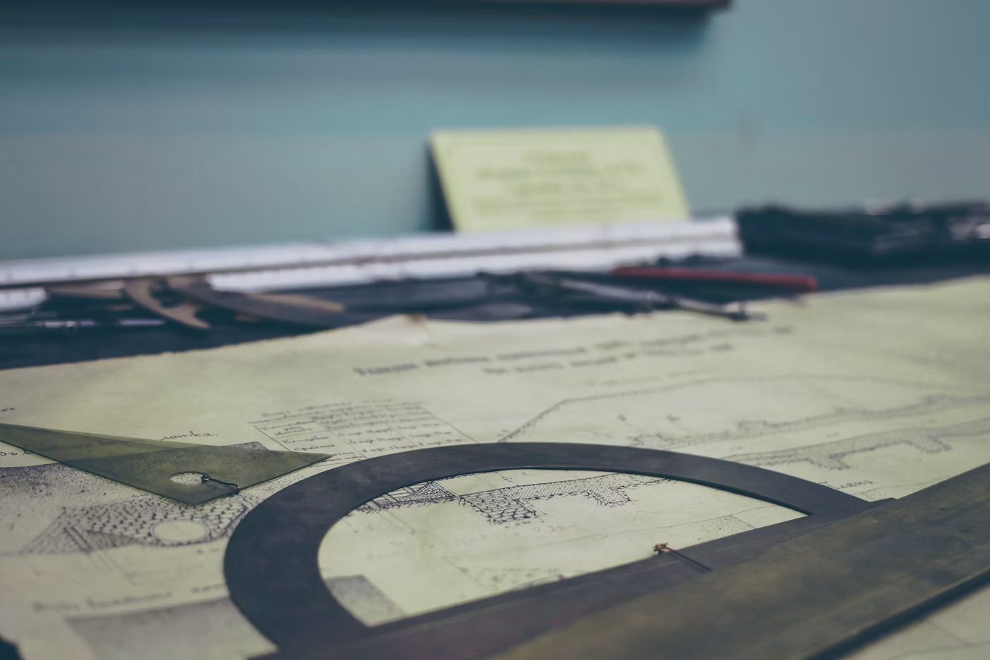 Architectural drawings with a compass and measuring tools on a desk